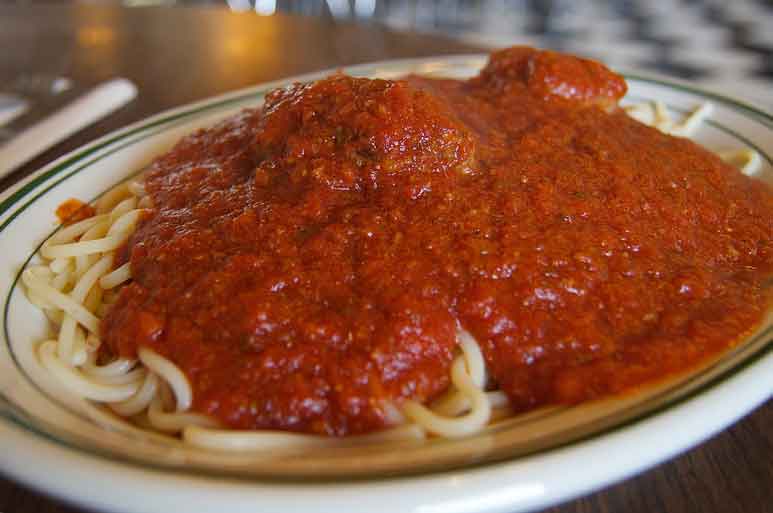 half orders of Spaghetti, Ravioli, and Rigatoni on a clean white plate